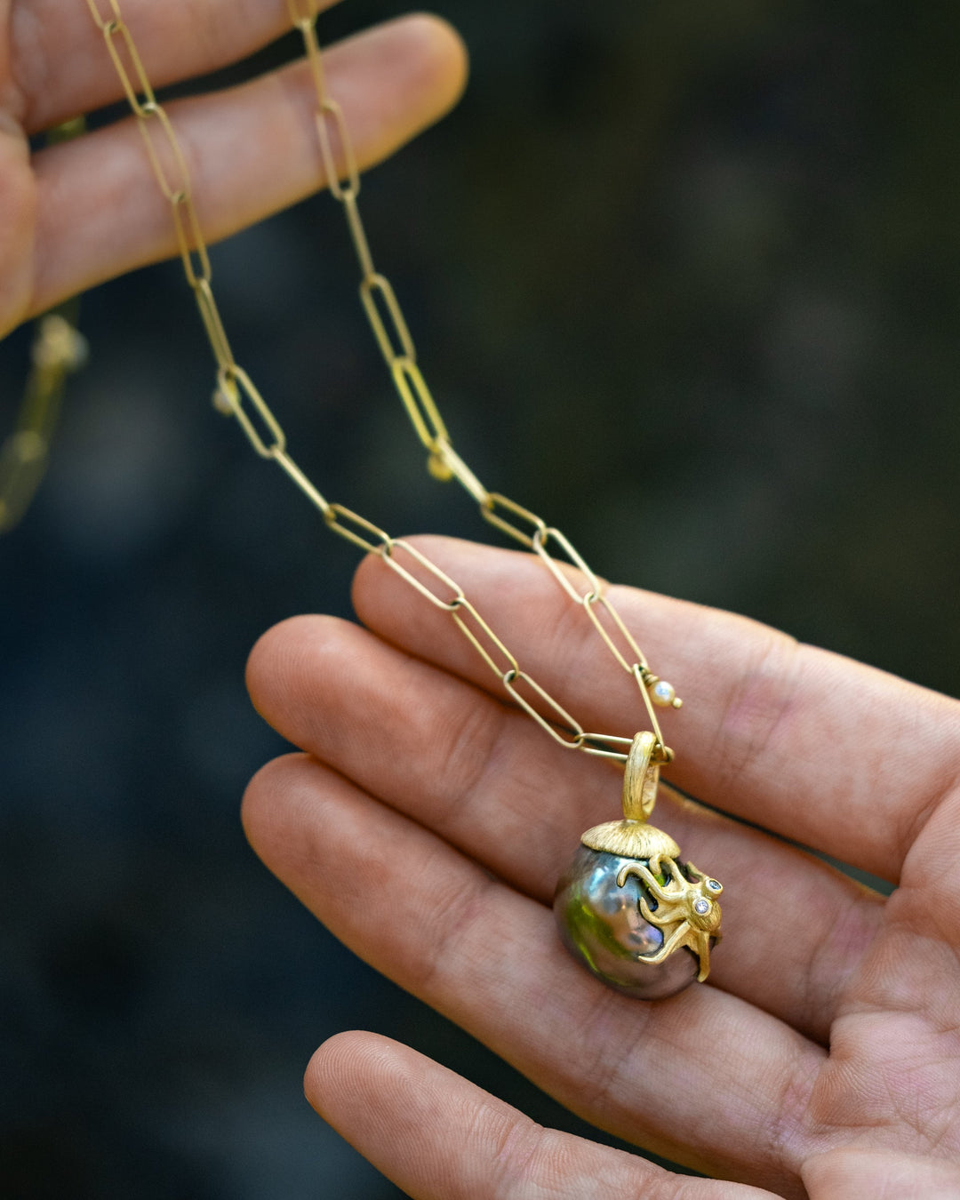 Handcrafted octopus pendant by Lene Vibe featuring a Tahitian pearl, photographed on a neutral background