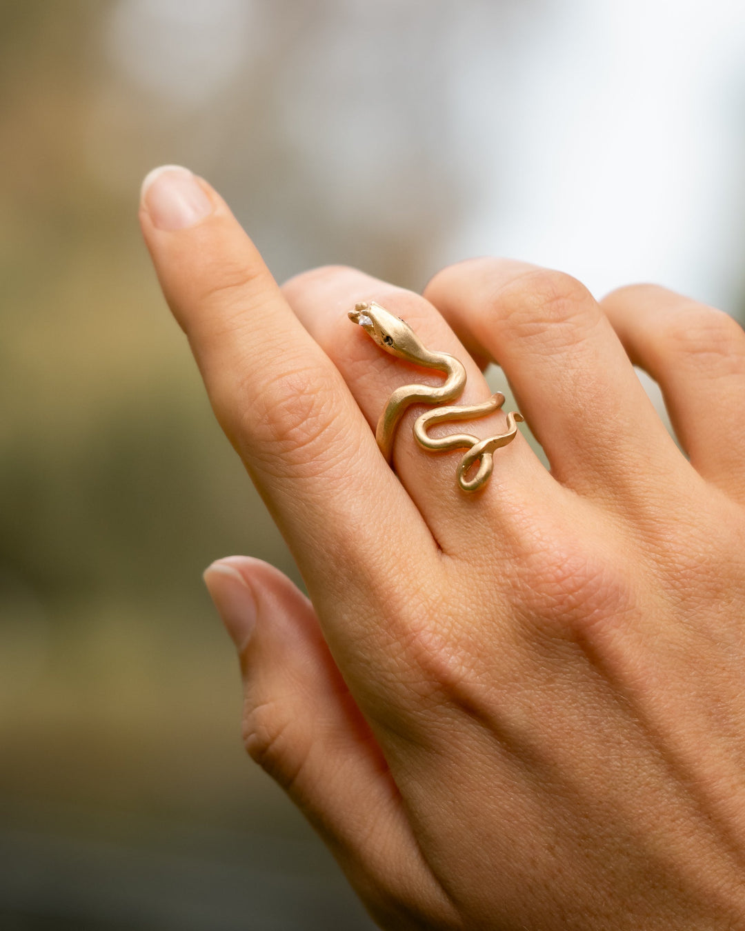 Dawes Design Sacred Serpent Ring: 14K gold snake coiled around finger with green diamond eyes and a diamond between its fangs